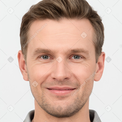 Joyful white young-adult male with short  brown hair and grey eyes