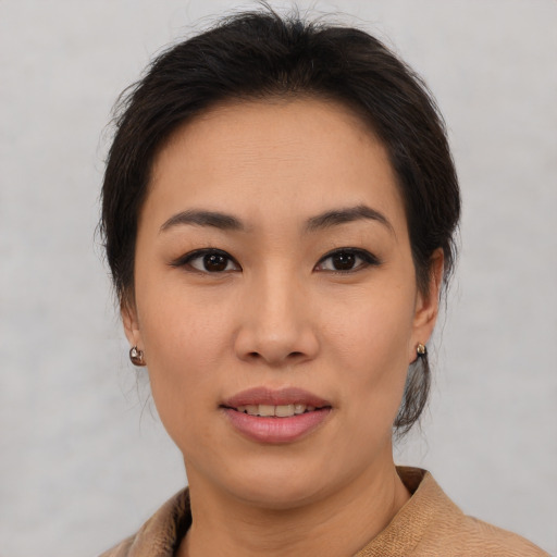 Joyful asian young-adult female with medium  brown hair and brown eyes