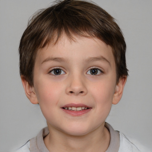 Joyful white child male with short  brown hair and brown eyes