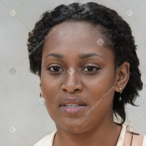 Joyful black young-adult female with medium  brown hair and brown eyes