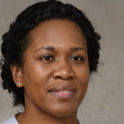 Joyful black adult female with medium  brown hair and brown eyes