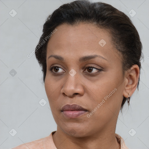 Joyful black adult female with short  brown hair and brown eyes