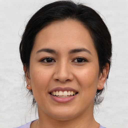 Joyful latino young-adult female with medium  brown hair and brown eyes