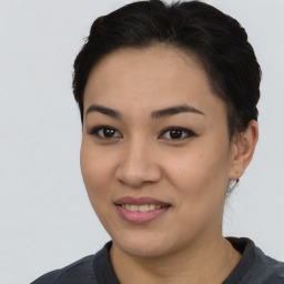 Joyful asian young-adult female with short  black hair and brown eyes