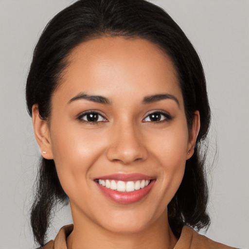 Joyful latino young-adult female with medium  black hair and brown eyes