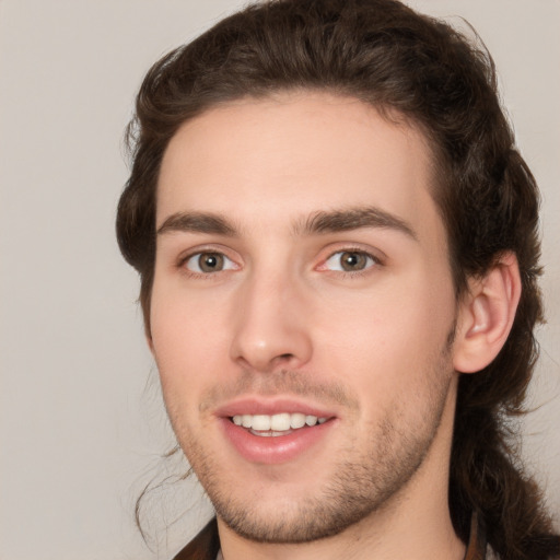 Joyful white young-adult male with medium  brown hair and brown eyes