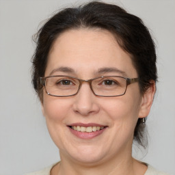 Joyful white adult female with medium  brown hair and brown eyes