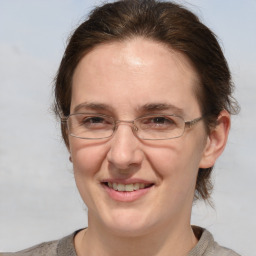 Joyful white adult female with medium  brown hair and grey eyes