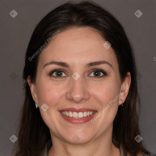 Joyful white adult female with long  brown hair and brown eyes