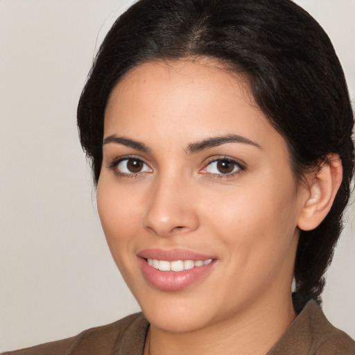 Joyful white young-adult female with long  brown hair and brown eyes