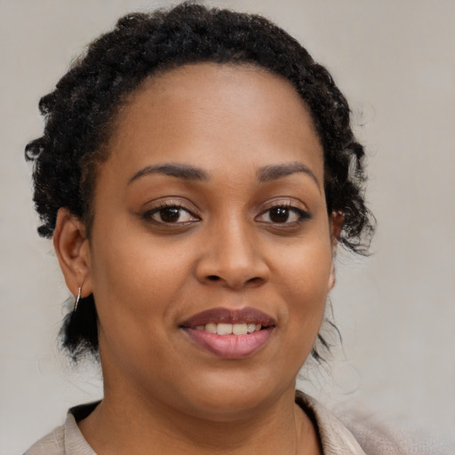 Joyful black young-adult female with medium  brown hair and brown eyes