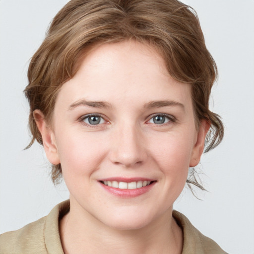 Joyful white young-adult female with medium  brown hair and blue eyes