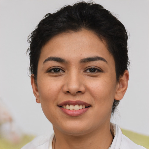 Joyful asian young-adult female with short  brown hair and brown eyes