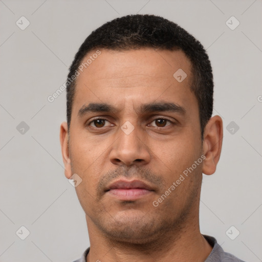 Neutral latino young-adult male with short  black hair and brown eyes