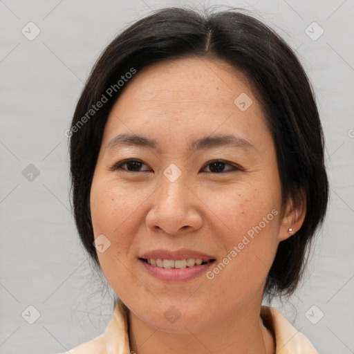 Joyful asian adult female with medium  brown hair and brown eyes