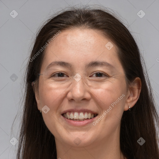 Joyful white adult female with long  brown hair and brown eyes