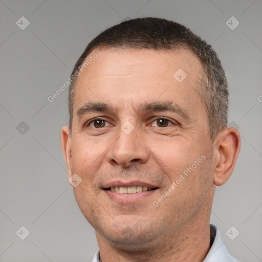 Joyful white adult male with short  brown hair and brown eyes