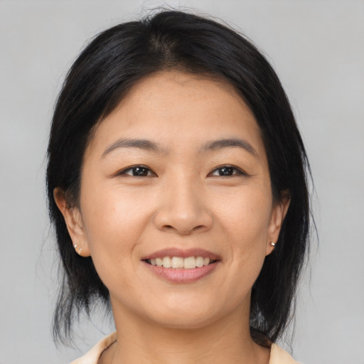 Joyful asian young-adult female with medium  brown hair and brown eyes