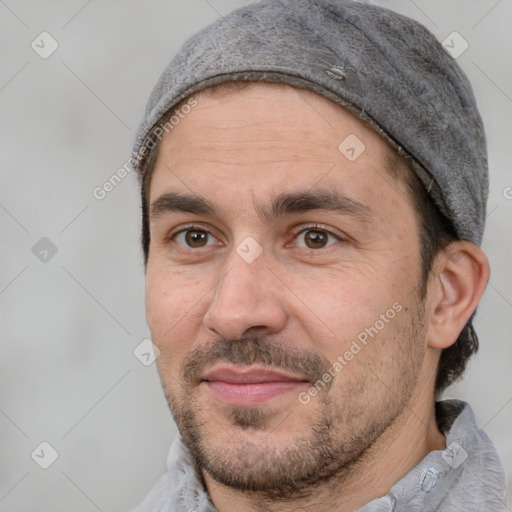 Joyful white adult male with short  black hair and brown eyes