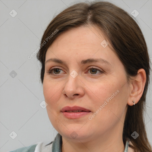 Joyful white adult female with medium  brown hair and grey eyes