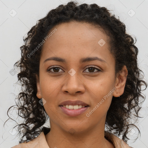 Joyful black young-adult female with long  brown hair and brown eyes