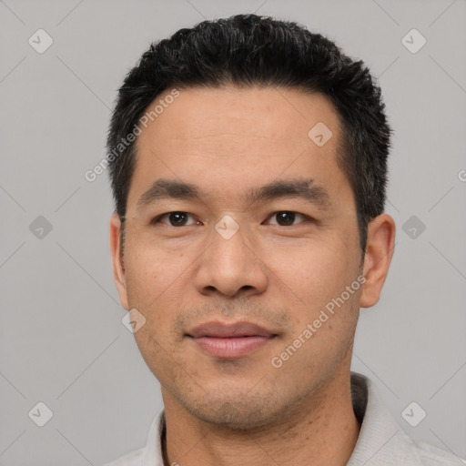 Joyful asian young-adult male with short  black hair and brown eyes