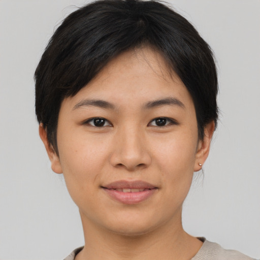 Joyful asian young-adult female with short  brown hair and brown eyes