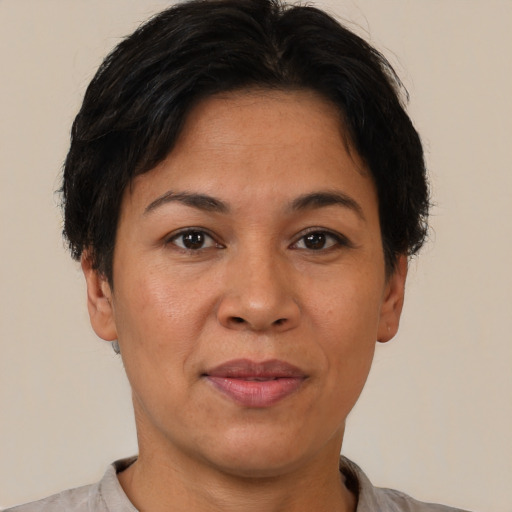 Joyful latino adult female with short  brown hair and brown eyes