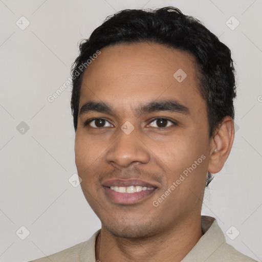 Joyful latino young-adult male with short  black hair and brown eyes