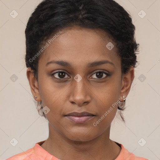 Joyful black young-adult female with short  brown hair and brown eyes