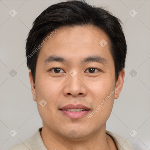 Joyful asian young-adult male with short  brown hair and brown eyes