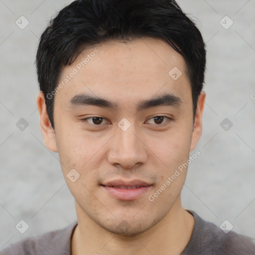 Joyful asian young-adult male with short  black hair and brown eyes