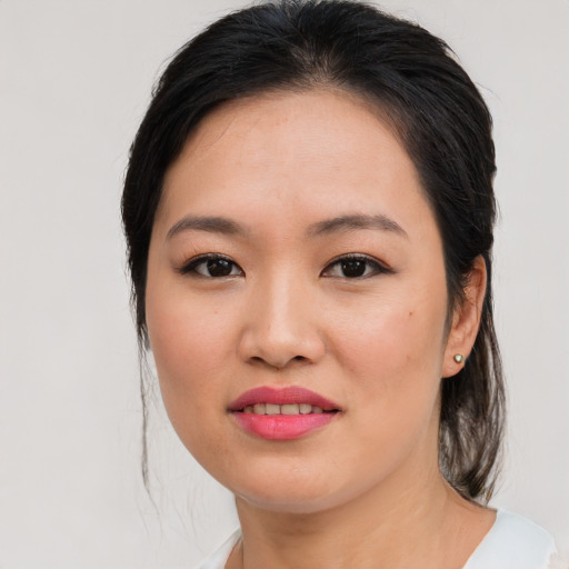 Joyful asian young-adult female with medium  brown hair and brown eyes