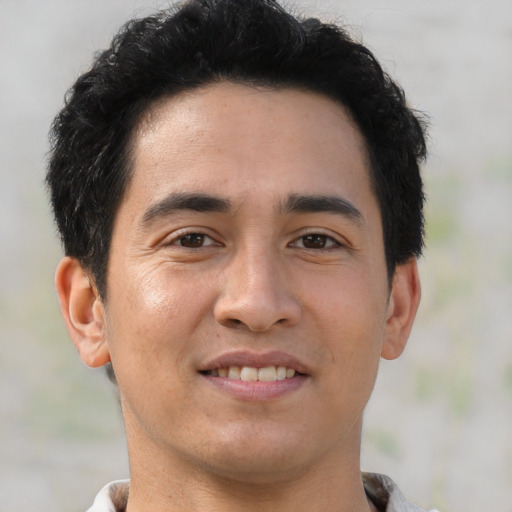 Joyful asian young-adult male with short  brown hair and brown eyes