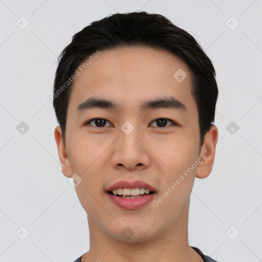 Joyful asian young-adult male with short  black hair and brown eyes