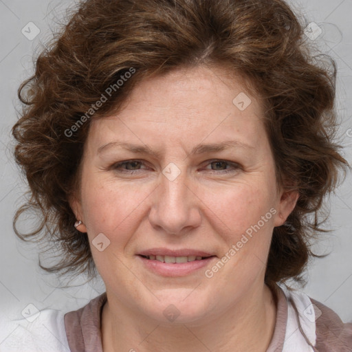 Joyful white adult female with medium  brown hair and blue eyes