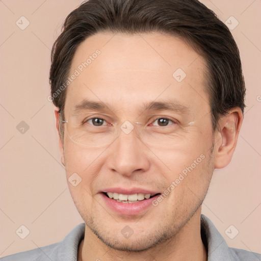 Joyful white adult male with short  brown hair and brown eyes