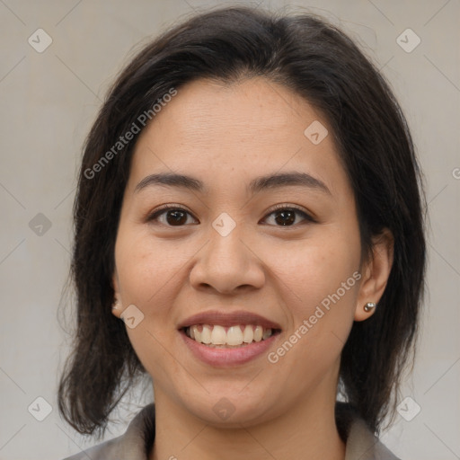 Joyful latino young-adult female with medium  brown hair and brown eyes