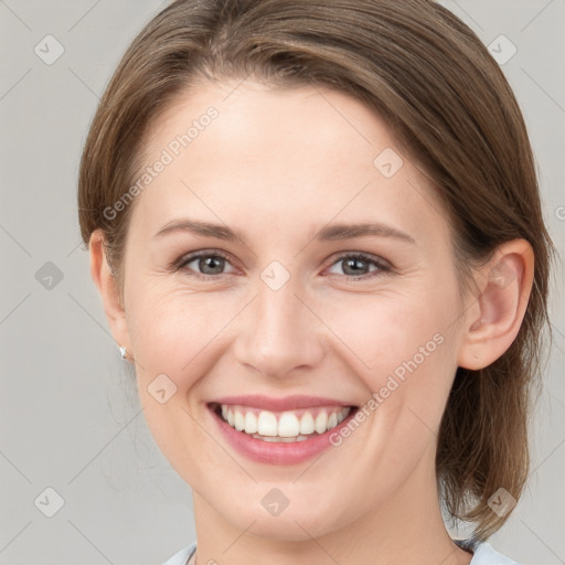 Joyful white young-adult female with medium  brown hair and grey eyes