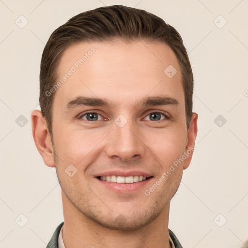 Joyful white young-adult male with short  brown hair and grey eyes