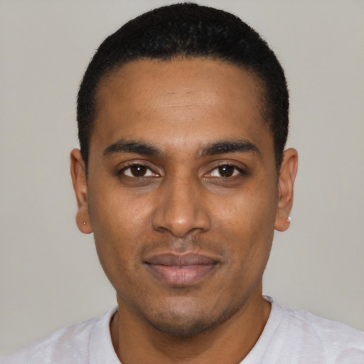 Joyful black young-adult male with short  black hair and brown eyes