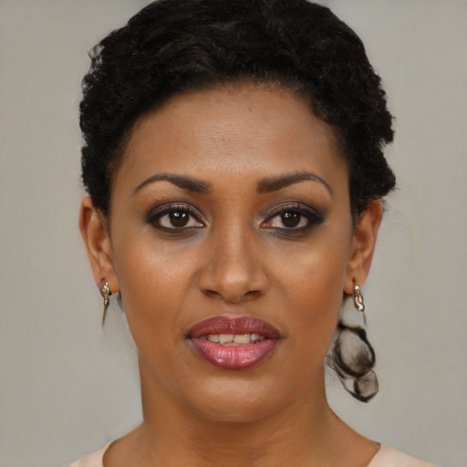 Joyful black young-adult female with short  brown hair and brown eyes