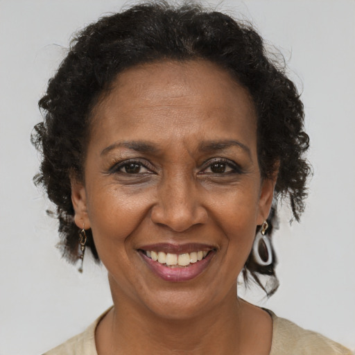 Joyful black adult female with short  brown hair and brown eyes