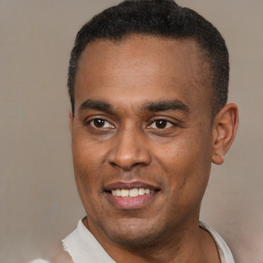 Joyful latino adult male with short  brown hair and brown eyes