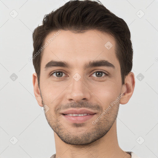 Joyful white young-adult male with short  brown hair and brown eyes