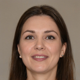 Joyful white adult female with medium  brown hair and brown eyes