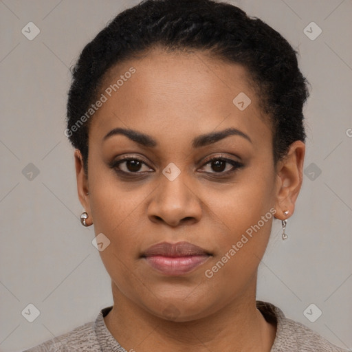 Joyful black young-adult female with short  black hair and brown eyes