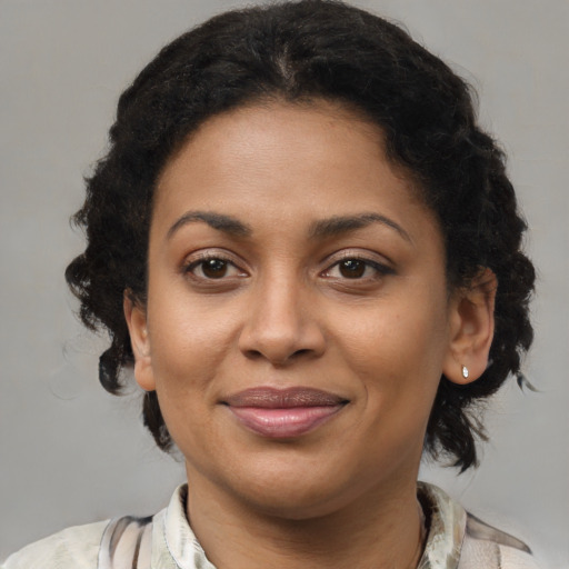 Joyful black young-adult female with medium  brown hair and brown eyes