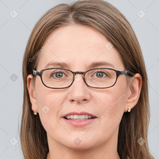 Joyful white adult female with long  brown hair and blue eyes