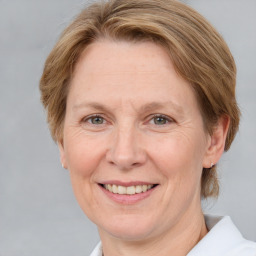 Joyful white adult female with medium  brown hair and grey eyes